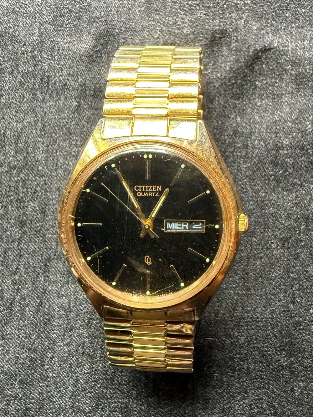 Vintage Citizen Quartz Watch with black dial gold tone case and flex band.